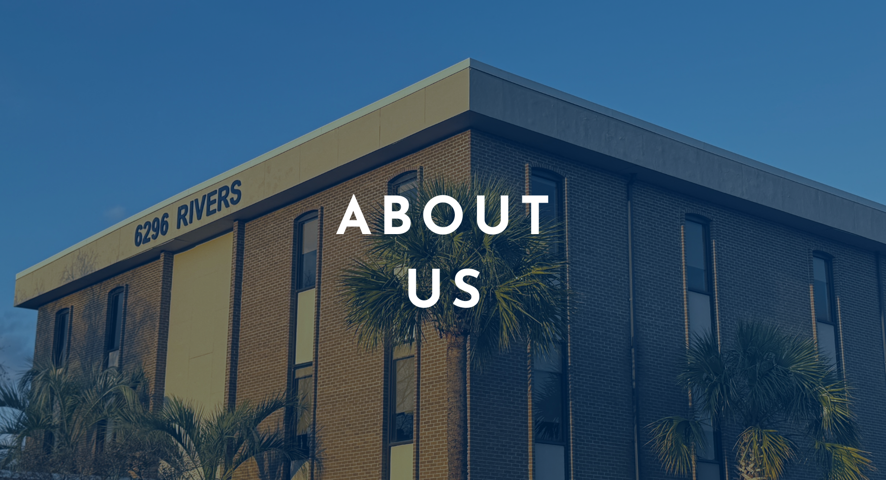 A shot of an office building shaded in navy and with white text saying about us.